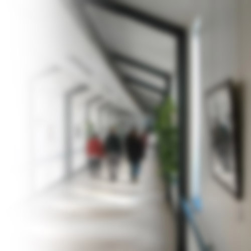 blurred image of patients walking through hospital corridor