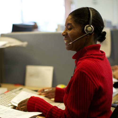 office staff member smiling with telephone headset